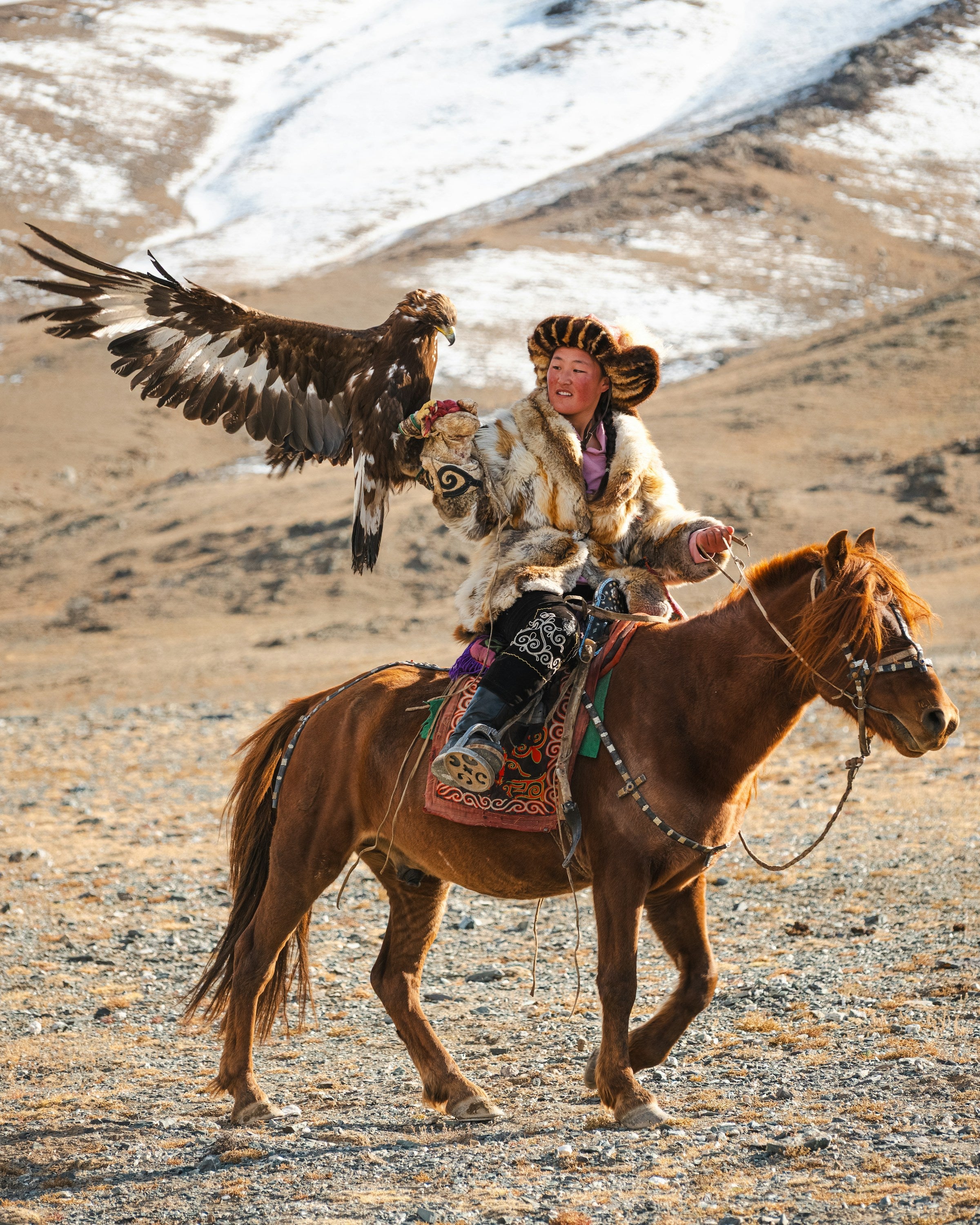 An eagle hunter on horseback