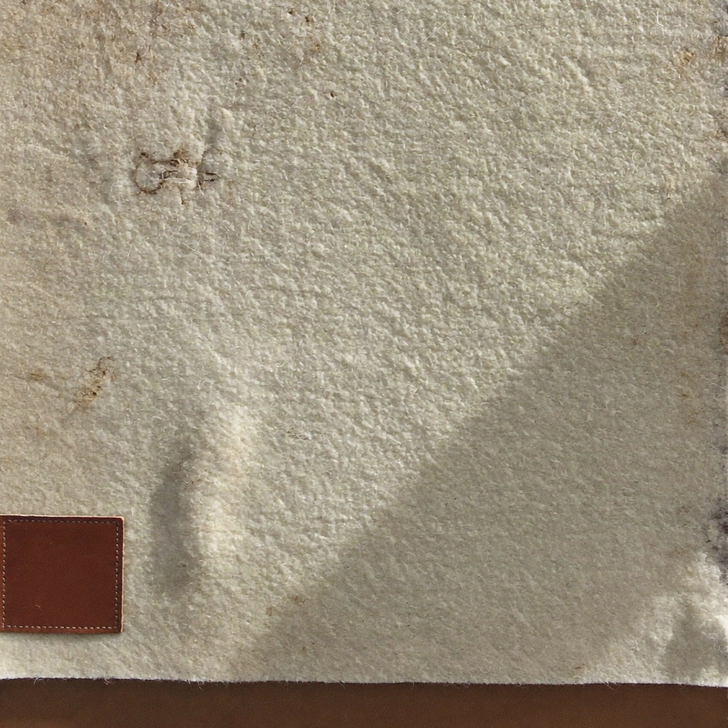 Pressed felt and leather patch detail