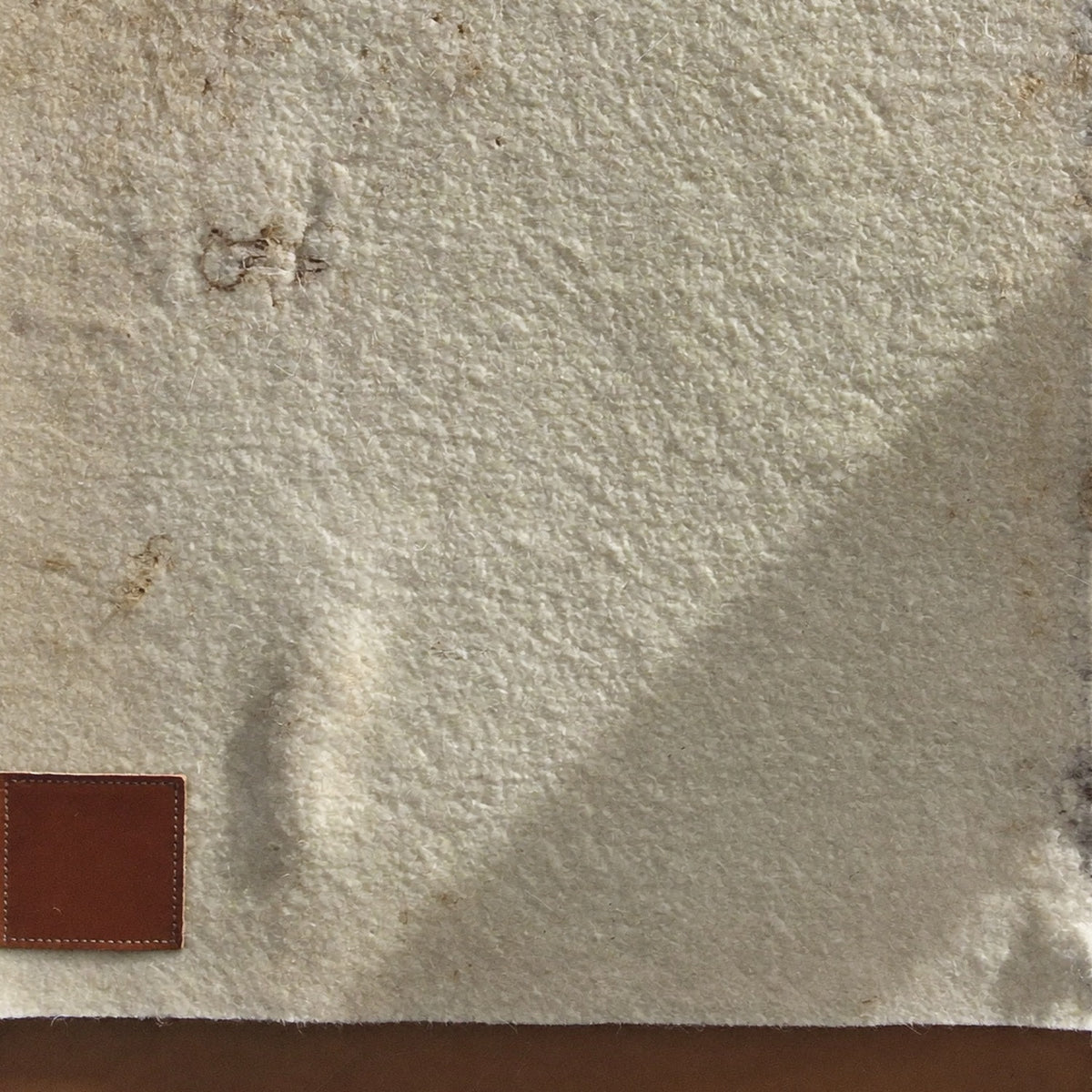 Pressed felt and leather patch detail