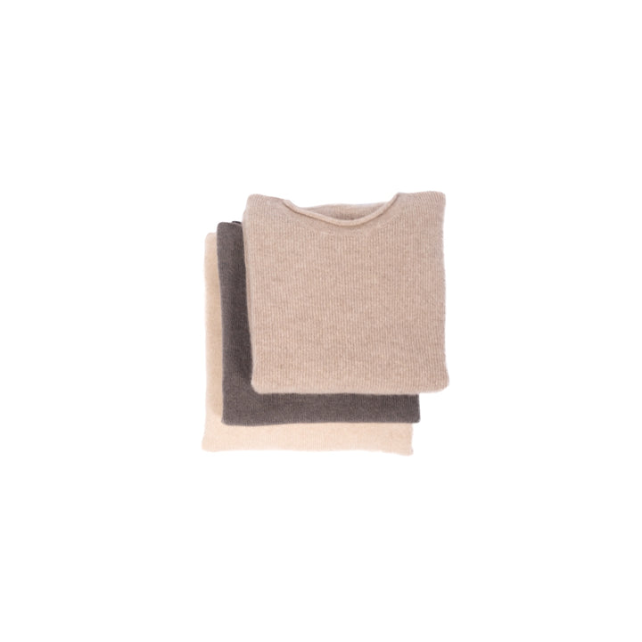 Women's wool and yak sweaters folded, three colorways