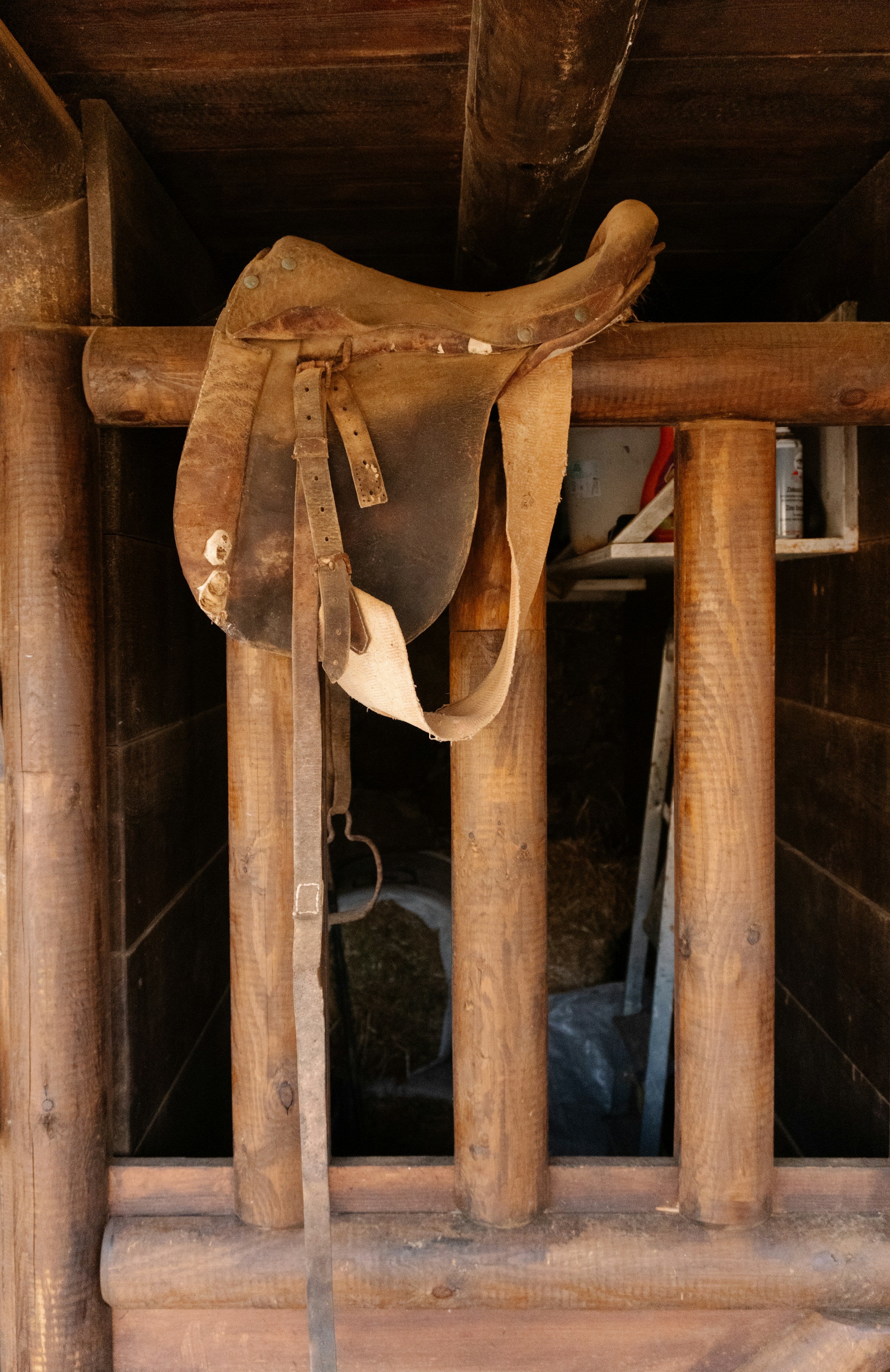 Leather saddle resting on wooden beams